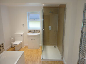 Completed bathroom with spacious shower.