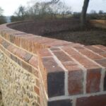 Traditional Stone Flint Walling | incorporating Flemmish Bond Brickwork with white Cement & Lime.