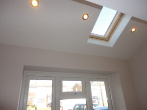 Vaulted ceiling feature with led spot lights and a velux window for added light.