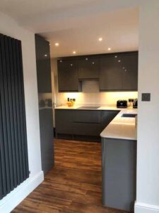 New kitchen with quartz worktop upright feature radiator and Karndene flooring.