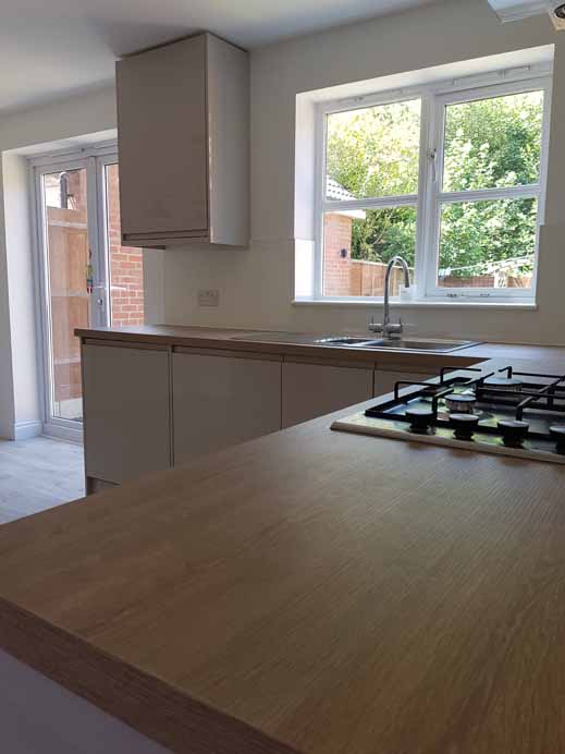 New modern kitchen incorporating downlights , splash backs and matching karndene flooring.