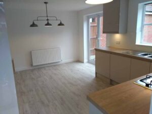 A partition wall has been removed to open the space for a larger new modern kitchen.