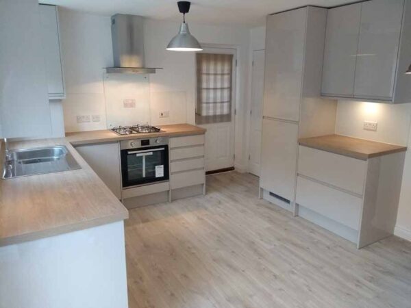 New modern kitchen incorporating downlights , splash backs and matching karndene flooring.