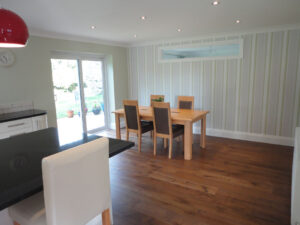 The converted garage has been transformed into a spacious downstairs room.